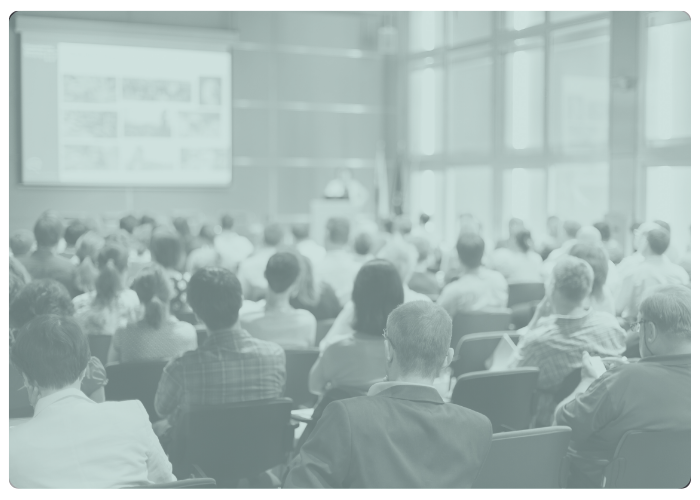 events card picture from the back of a crowd at a presentation