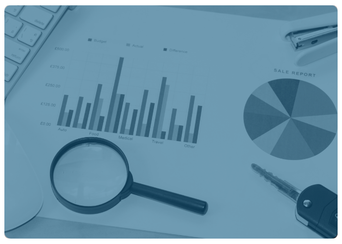 magnifying glass laying on top of printed graphs